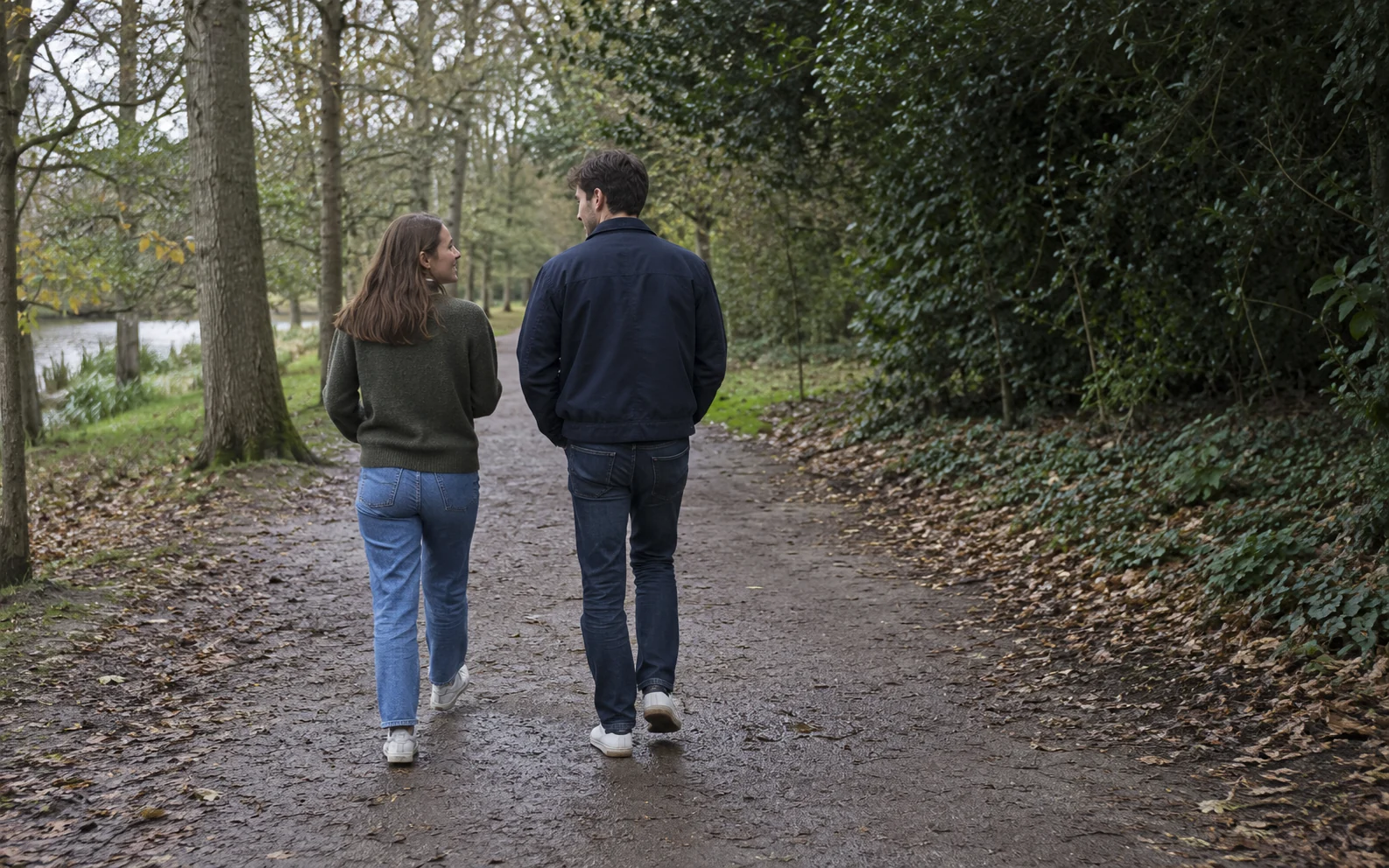 A couple walking and talking on a path outdoors